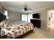 Bright bedroom featuring a ceiling fan, flatscreen tv, and access to the pool area at 5262 Weatherton St, North Port, FL 34288