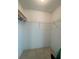 Walk-in closet with white walls, tiled floors, and wire shelving at 5262 Weatherton St, North Port, FL 34288