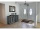 Bright foyer features a decorative cabinet, tiled floors and double front doors with oval windows at 5262 Weatherton St, North Port, FL 34288