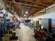 Large garage space with overhead wood beams, and filled with an array of tools, bicycles, and machines at 5262 Weatherton St, North Port, FL 34288