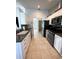 Modern kitchen with white cabinets, stainless steel appliances, and dark counter tops at 5262 Weatherton St, North Port, FL 34288