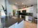 Charming kitchen features white cabinetry, stainless appliances, dark counters, and stylish backsplash at 5262 Weatherton St, North Port, FL 34288
