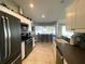 Cozy kitchen includes stainless appliances, white cabinets, breakfast nook, and dark countertops at 5262 Weatherton St, North Port, FL 34288