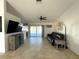 Bright living room featuring neutral tile, fan, and sliding doors to the lanai/pool area at 5262 Weatherton St, North Port, FL 34288