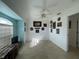Well-lit living room features tile floors and fan at 5262 Weatherton St, North Port, FL 34288