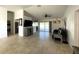 Open-concept living room features neutral tile, fan, modern lighting, and sliding doors to the pool at 5262 Weatherton St, North Port, FL 34288