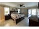 Main bedroom boasts a ceiling fan, tile floors, sliding door access to lanai, and large windows at 5262 Weatherton St, North Port, FL 34288