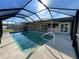 Screened in pool with a concrete pool deck, home, and fenced yard beyond at 5262 Weatherton St, North Port, FL 34288