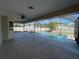 A screen enclosed pool is surrounded by a concrete deck and a covered lounge area at 5262 Weatherton St, North Port, FL 34288