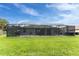 Spacious backyard with a screened-in pool and plenty of room for outdoor activities at 59 Long Meadow Ln, Rotonda West, FL 33947