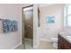 Bathroom featuring a glass enclosed shower and tiled walls at 59 Long Meadow Ln, Rotonda West, FL 33947