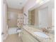 Bathroom featuring granite countertops, framed mirror, and decorative shower curtain at 59 Long Meadow Ln, Rotonda West, FL 33947