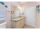 Bathroom featuring granite countertops, framed mirror, and wall-mounted towel rack at 59 Long Meadow Ln, Rotonda West, FL 33947