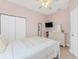 Bedroom featuring a double bed, dresser, and mounted TV at 59 Long Meadow Ln, Rotonda West, FL 33947