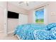 Bedroom featuring closet doors, blue bedding, and a bright outdoor view at 59 Long Meadow Ln, Rotonda West, FL 33947
