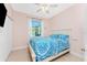 Bedroom featuring blue bedding, neutral walls, and a window with a bright outdoor view at 59 Long Meadow Ln, Rotonda West, FL 33947