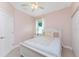 Cozy bedroom featuring neutral walls, decorative bedding, and a ceiling fan at 59 Long Meadow Ln, Rotonda West, FL 33947