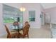 Bright dining area with a round glass table, 4 chairs, and a large window with lovely natural light at 59 Long Meadow Ln, Rotonda West, FL 33947