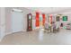 Open-concept dining area with a chandelier, tile floors, and natural light at 59 Long Meadow Ln, Rotonda West, FL 33947