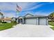 Charming single-story home with well-manicured lawn, palm trees, and a spacious three-car garage at 59 Long Meadow Ln, Rotonda West, FL 33947