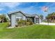Charming home featuring a well-manicured lawn and attractive landscaping at 59 Long Meadow Ln, Rotonda West, FL 33947