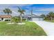 Lovely home with a manicured lawn, mature trees and a spacious three-car garage at 59 Long Meadow Ln, Rotonda West, FL 33947