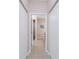 Hallway leading to the bathroom featuring tiled floors and neutral paint color at 59 Long Meadow Ln, Rotonda West, FL 33947