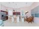 Eat-in kitchen has pendant lighting and breakfast bar seating with modern stainless-steel appliances at 59 Long Meadow Ln, Rotonda West, FL 33947