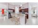 Kitchen features a granite counter island with seating, stainless-steel appliances, and ample cabinet space at 59 Long Meadow Ln, Rotonda West, FL 33947