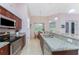 Well-equipped kitchen with granite counters, stainless appliances, and a breakfast bar at 59 Long Meadow Ln, Rotonda West, FL 33947