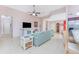 Inviting living room features neutral tile floors, contemporary furnishings, and a ceiling fan at 59 Long Meadow Ln, Rotonda West, FL 33947
