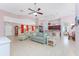Spacious living room with a ceiling fan, tile flooring, and flows into the dining area at 59 Long Meadow Ln, Rotonda West, FL 33947