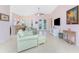 Bright and airy living room featuring tile floors, ceiling fan, and French doors to the outdoor space at 59 Long Meadow Ln, Rotonda West, FL 33947