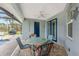 Screened-in patio features brick pavers, a ceiling fan, and outdoor furniture at 59 Long Meadow Ln, Rotonda West, FL 33947