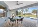 Screened-in patio features brick pavers, a ceiling fan, and outdoor furniture at 59 Long Meadow Ln, Rotonda West, FL 33947