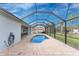 Relax in this screened-in pool with brick pavers and ample space for entertaining at 59 Long Meadow Ln, Rotonda West, FL 33947