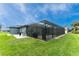 This home has a lovely screened-in pool with lush green lawn and room to grill at 59 Long Meadow Ln, Rotonda West, FL 33947