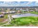 Aerial shot overlooking the community's golf course and pond, with residential homes in the backdrop at 7 Windward Rd, Placida, FL 33946