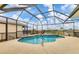 Inviting pool area enclosed by a screened lanai offering panoramic views of the golf course at 7 Windward Rd, Placida, FL 33946