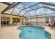 Covered pool and lanai with seating area, offering a relaxing outdoor experience at 7 Windward Rd, Placida, FL 33946