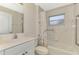 This bathroom features tiled walls, a shower and tub combo, and safety bars at 7151 Cork Ln, Englewood, FL 34224