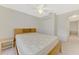 This bedroom features a light wood bed frame and a closet for plenty of storage space at 7151 Cork Ln, Englewood, FL 34224