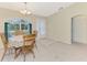 Bright dining area with a decorative table and chairs by the front door at 7151 Cork Ln, Englewood, FL 34224