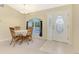 Dining room with a decorative table and chairs next to the front door at 7151 Cork Ln, Englewood, FL 34224