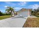 Well-maintained single-story home with a two-car garage and a concrete driveway at 7151 Cork Ln, Englewood, FL 34224