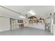 The garage features a metal roll up door and shelves for storage at 7151 Cork Ln, Englewood, FL 34224