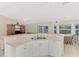 Open kitchen featuring white countertops and cabinets overlooking the dinette and living area at 7151 Cork Ln, Englewood, FL 34224