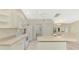 Bright and airy kitchen featuring white cabinets, modern appliances, and a view into the dining area at 7151 Cork Ln, Englewood, FL 34224