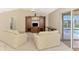 Spacious living room boasts an entertainment center and glass doors overlooking the pool at 7151 Cork Ln, Englewood, FL 34224