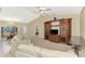 Inviting living room with entertainment center, adjacent to dining area and front entryway at 7151 Cork Ln, Englewood, FL 34224